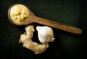 garlic, ginger and wooden spoon