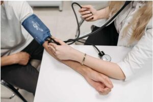 arm of patient being measured for blood pressure