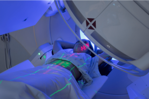 person lying on table receiving radiation treatment